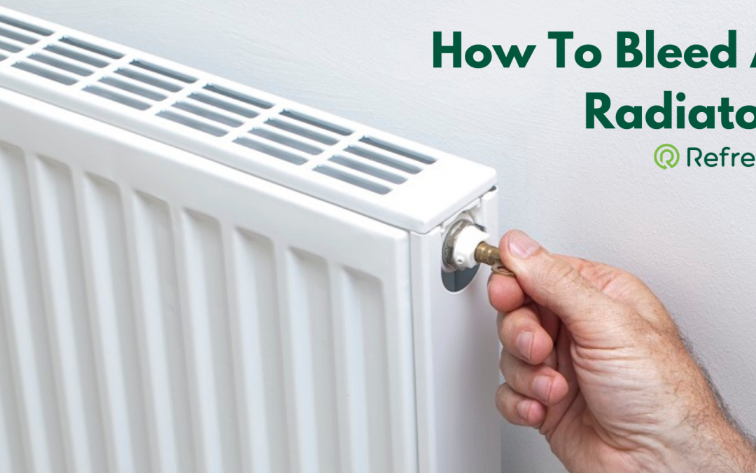 Hand checking a radiator for cold patches at the bottom — a sign of magnetite sludge in a London central heating system