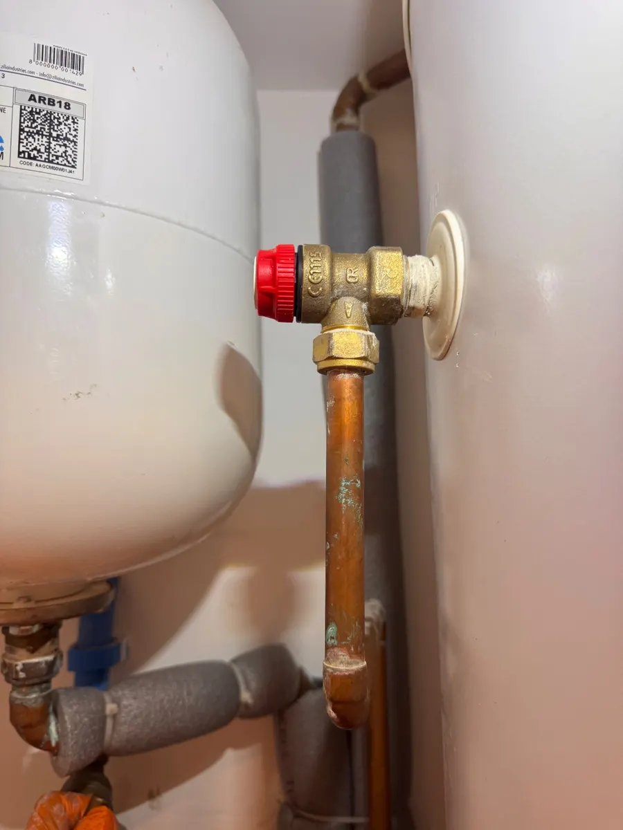 An expansion vessel and red-topped relief valve beside an unvented cylinder