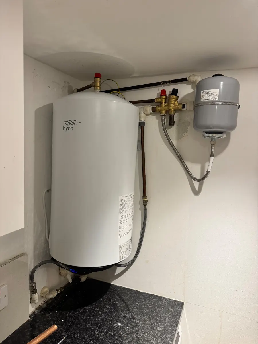 A new 50 litre cylinder with its expansion vessel and valve group fitted above a kitchen worktop
