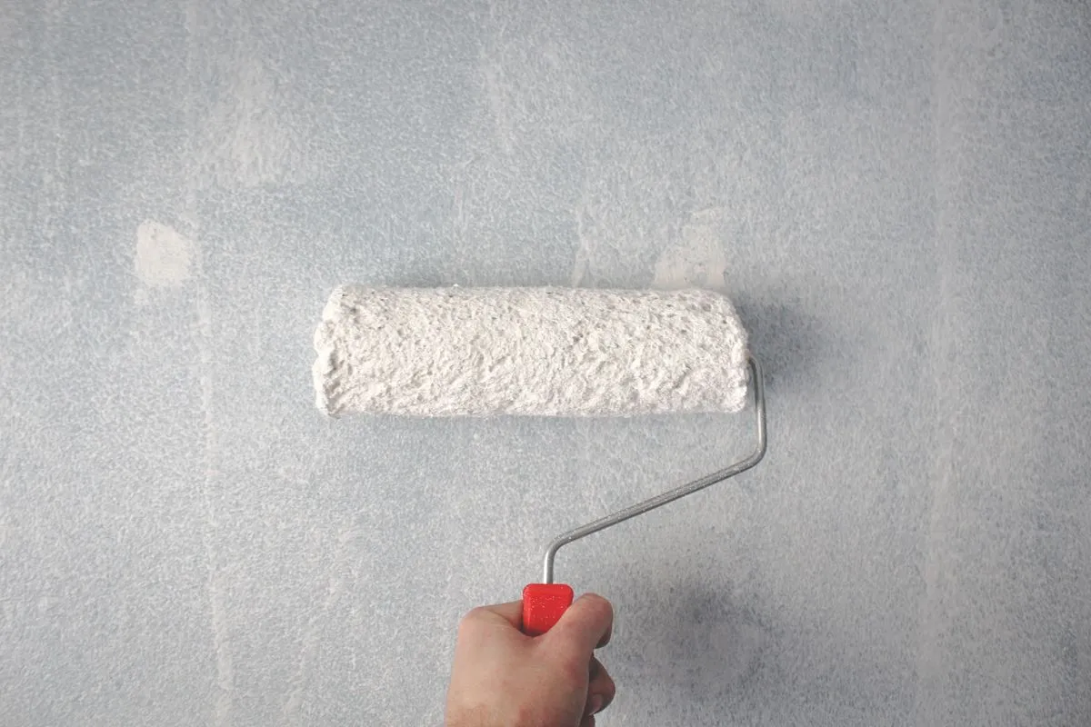 Professional decorator painting a room in a London property - interior decorating service